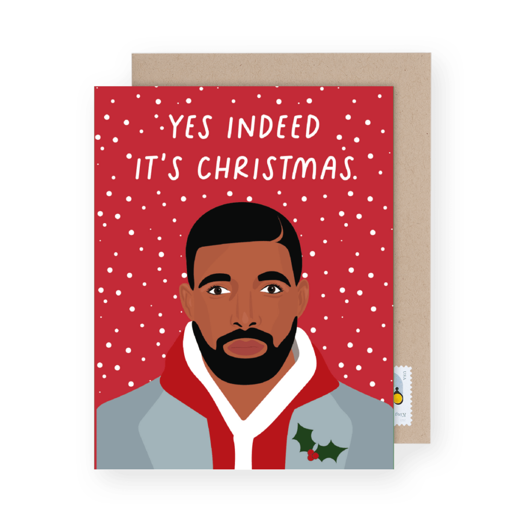 Illustrated holiday card with a man in a suit and red hoodie, holly decoration on lapel, with the text "YES INDEED IT'S CHRISTMAS" on a snowy red background.