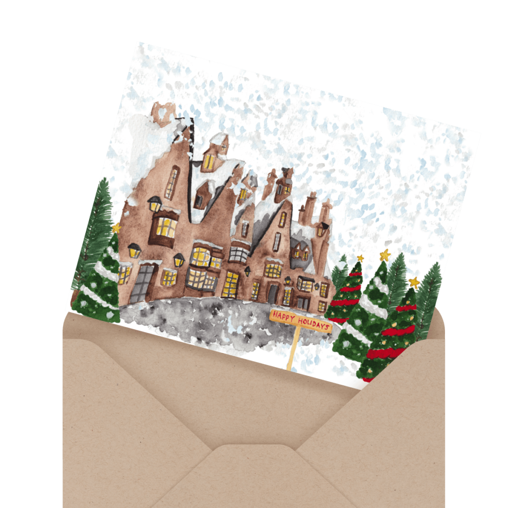 A holiday card with a snowy village scene is partially inserted into a brown envelope.