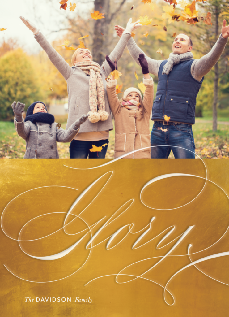 A family of four in warm clothes plays with autumn leaves in a park. The word "Glory" is written in large cursive text across the image.