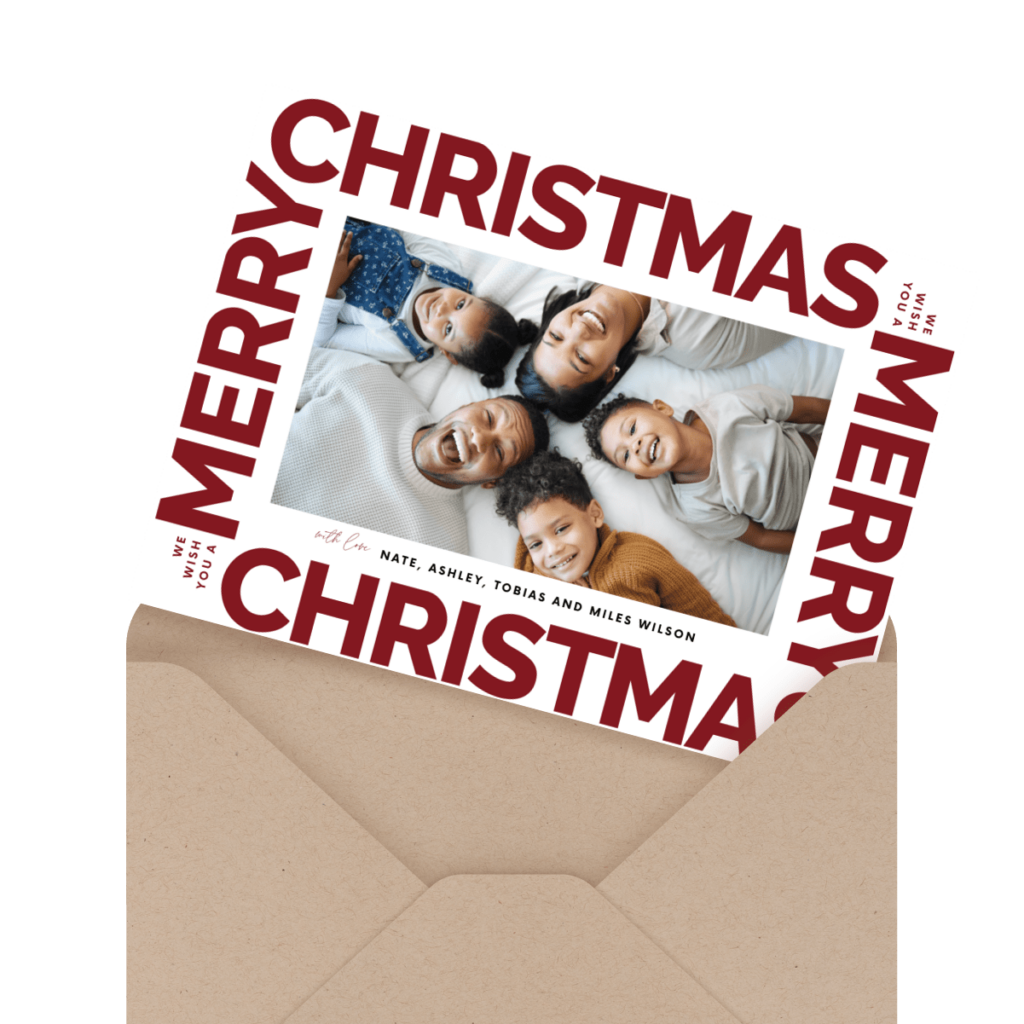 Holiday card with a family photo inside an envelope. The card reads "Merry Christmas" in bold red letters.