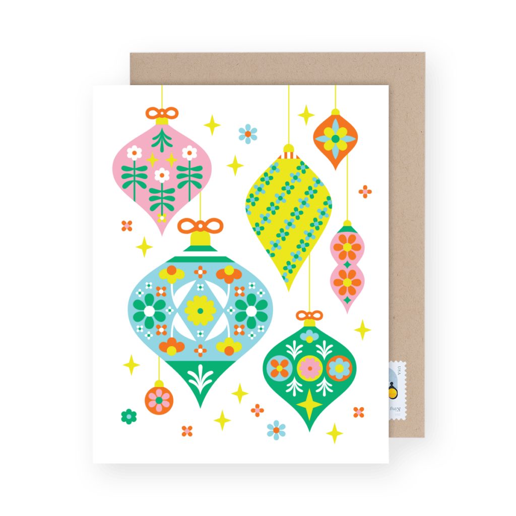 Festive card featuring colorful, vintage-style ornaments and flowers on a white background, perfect for complementing any Christmas party themes, accompanied by a classic brown envelope.