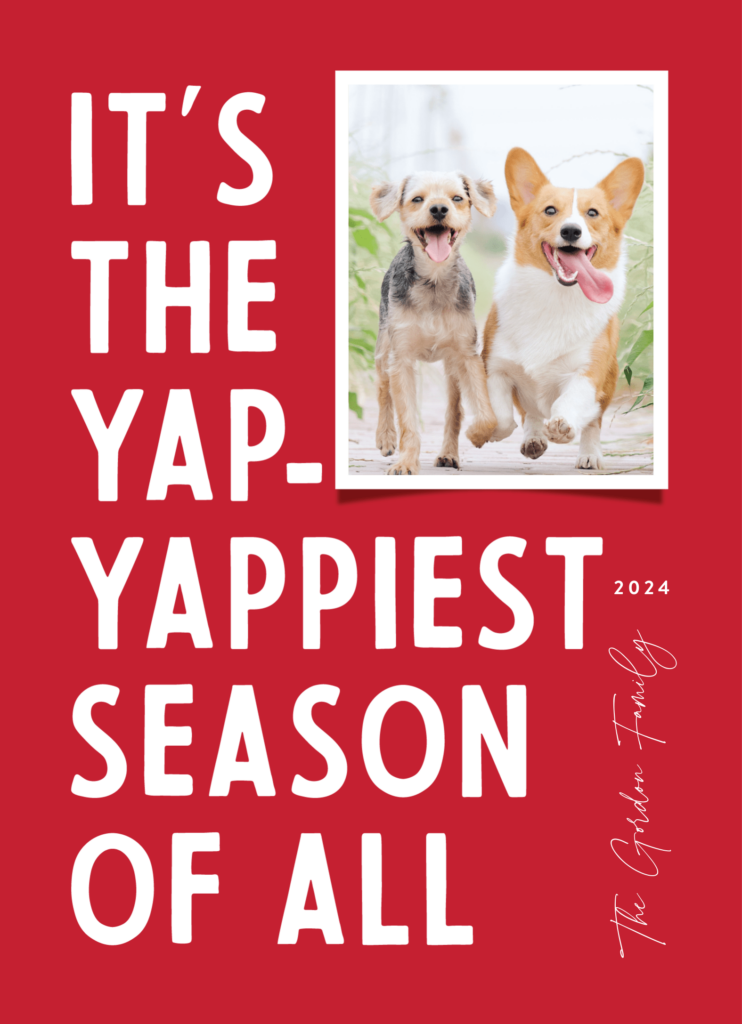 Red holiday card with two dogs running joyfully. Text reads: "IT'S THE YAP-YAPPIEST SEASON OF ALL" with the year 2024. A handwritten note says "The Gardner Family" on the side.