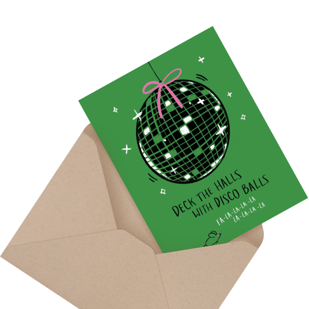 Greeting card with a disco ball illustration reads "Deck the Halls with Disco Balls" on a green background, partially inside a brown envelope.