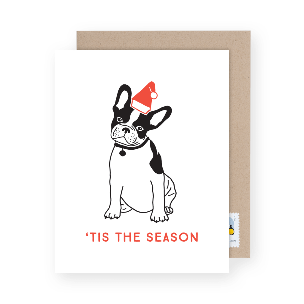 Illustration of a French Bulldog wearing a Santa hat on a greeting card with the text "'TIS THE SEASON" in red.