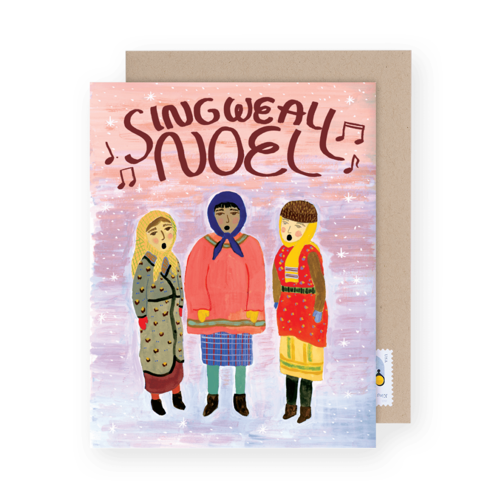 Illustrated greeting card with three people singing. The text "Sing We All Noel" appears at the top with musical notes around it. Background is a starry pink and purple sky.