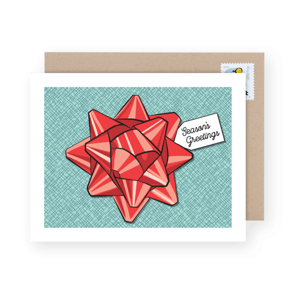 Greeting card with a red bow and "Season's Greetings" text on the front, placed in front of a brown envelope with a stamp.