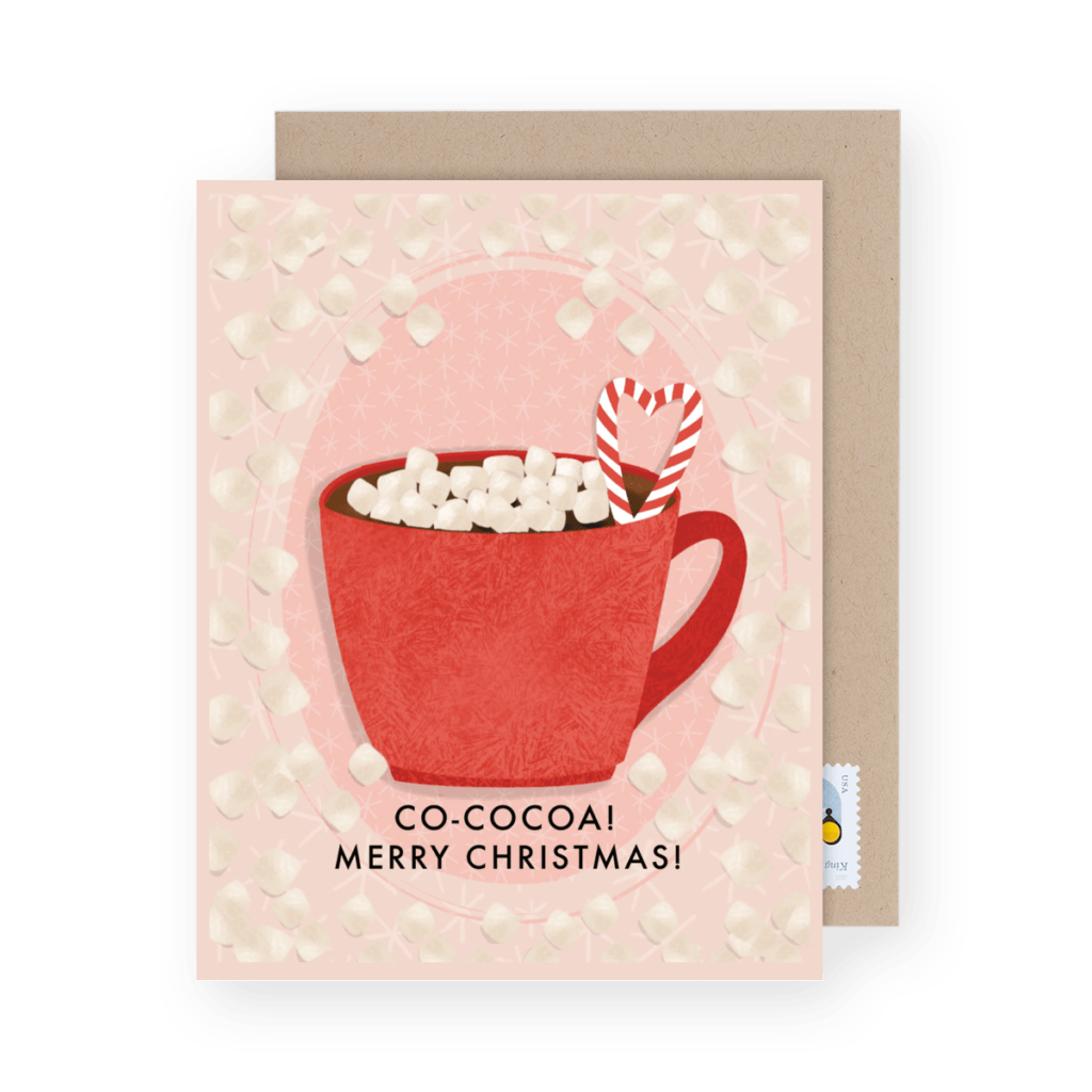 A Christmas card featuring a red mug of hot cocoa with marshmallows and a candy cane. Text reads "CO-COCOA! Merry Christmas!" on a pink background with marshmallow designs.